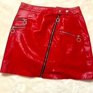 Faux Leather Skirt with zippers. Model is 5’3. Skirt is a medium 6-8.